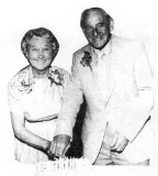 Mr. & Mrs. Aitkenhead cutting their cake.